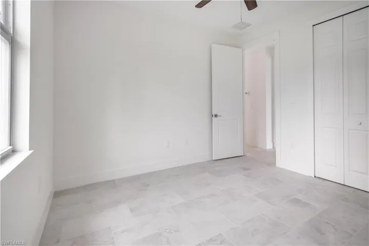 Unfurnished bedroom featuring ceiling fan and a closet