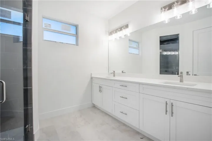 Bathroom featuring vanity and an enclosed shower