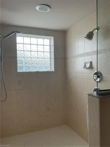 master Bathroom featuring tiled shower with multiple shower heads