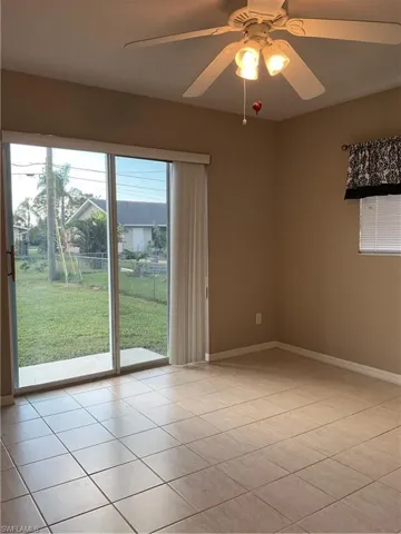 Tiled spare room with ceiling fan & sliders to back yard
