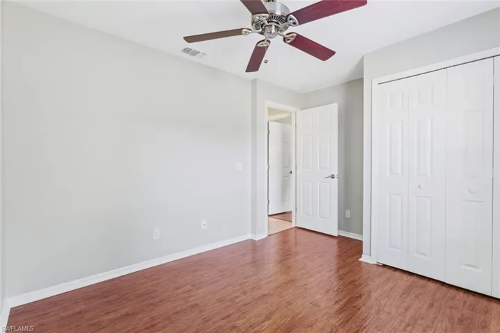 Guest Bedroom 3-featuring wood floors, ceiling fan, and closet