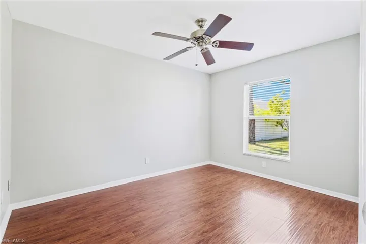 Guest Bedroom 2-featuring wood floors, ceiling fan and closet