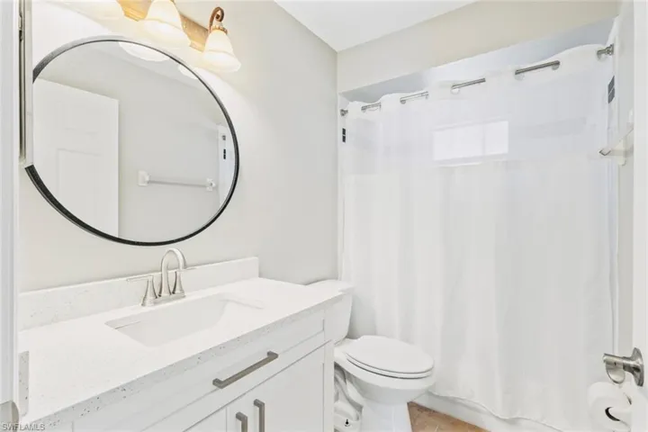 Guest Bathroom with vanity, neutral tile patterned floors, and shower / bath combo
