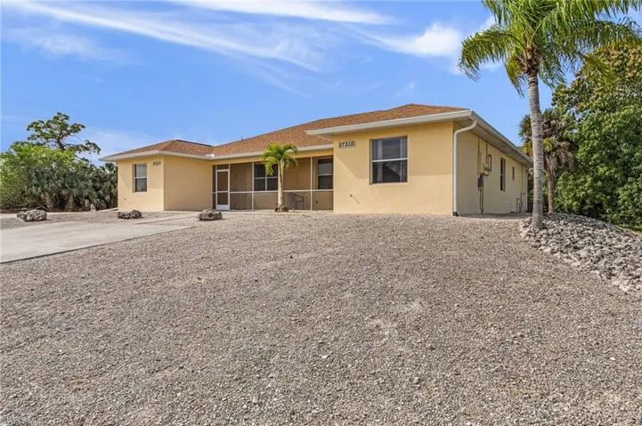 Single story home with stucco siding and a sunroom
