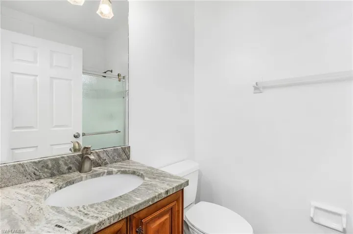 Full bath with vanity and an enclosed shower
