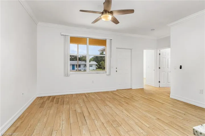 Living room featuring wood-style tiled floors, and ceiling fan
