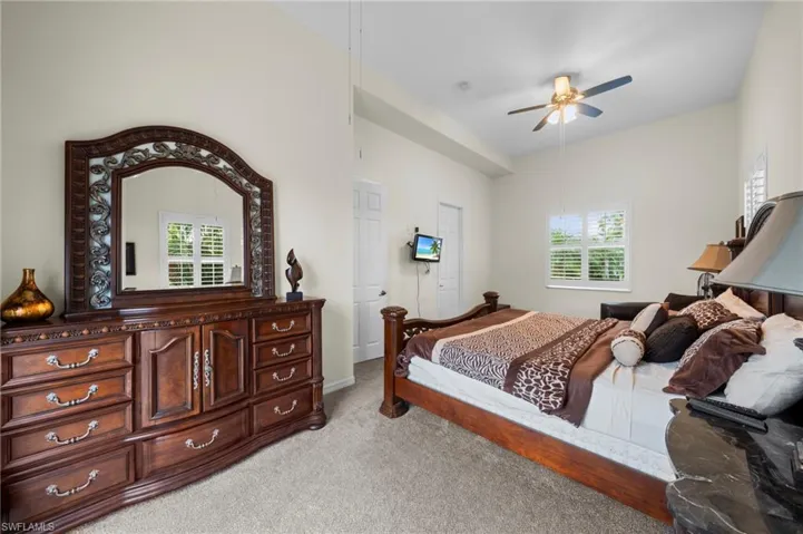 Bedroom with light colored carpet and ceiling fan