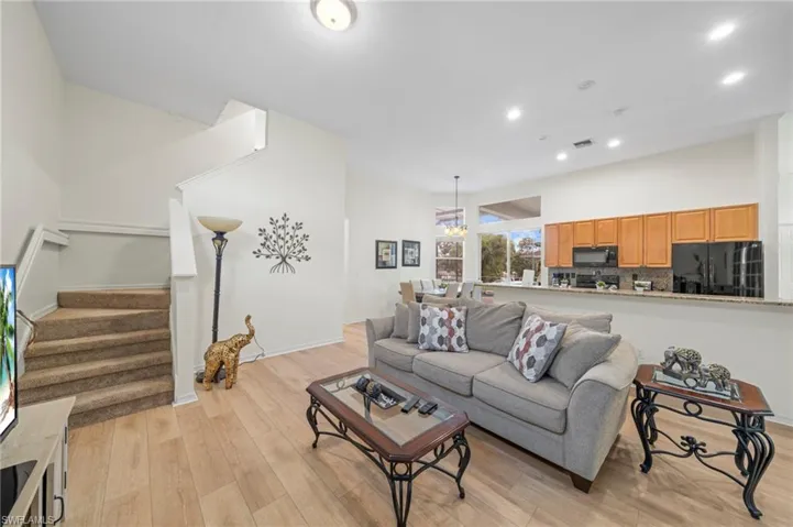 Living room with light wood finished floors and recessed lighting