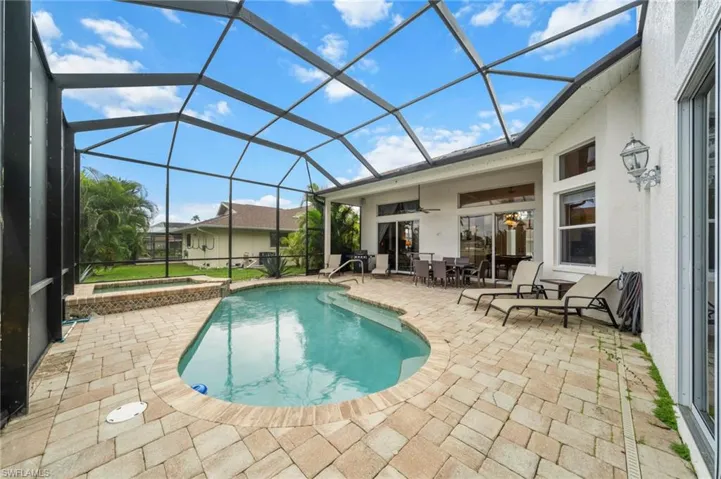 Integrated pool / spa featuring a sunroom, a patio, and outdoor dining space