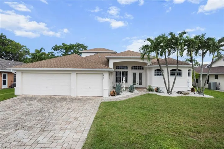 Ranch-style house featuring french doors, a garage, driveway, and stucco siding