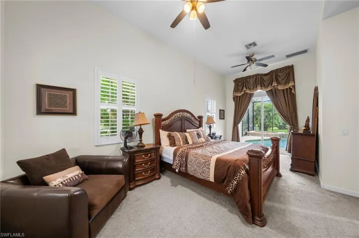 Carpeted bedroom featuring access to exterior and ceiling fan