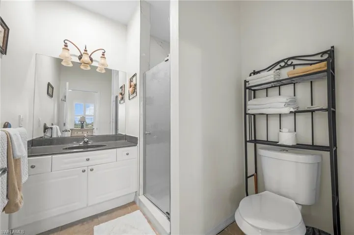 Bathroom featuring a stall shower and vanity