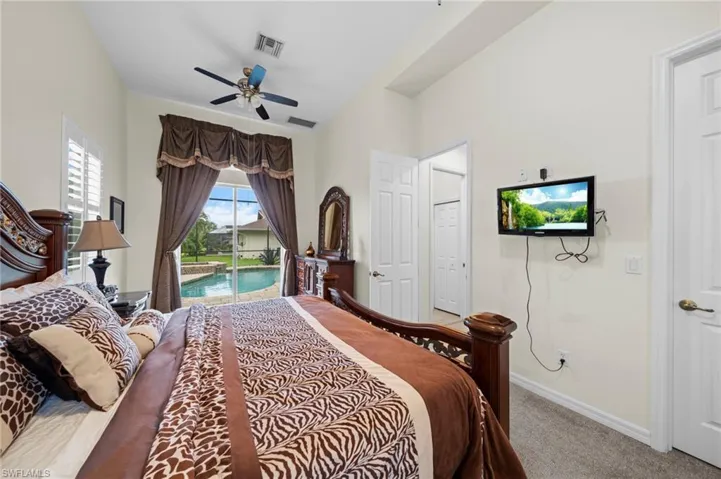 Bedroom featuring access to outside, light carpet, and ceiling fan