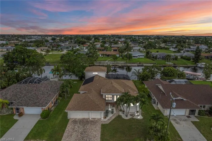 Aerial perspective of suburban area featuring a large body of water