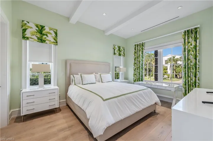 Bedroom featuring beam ceiling and light hardwood / wood-style flooring