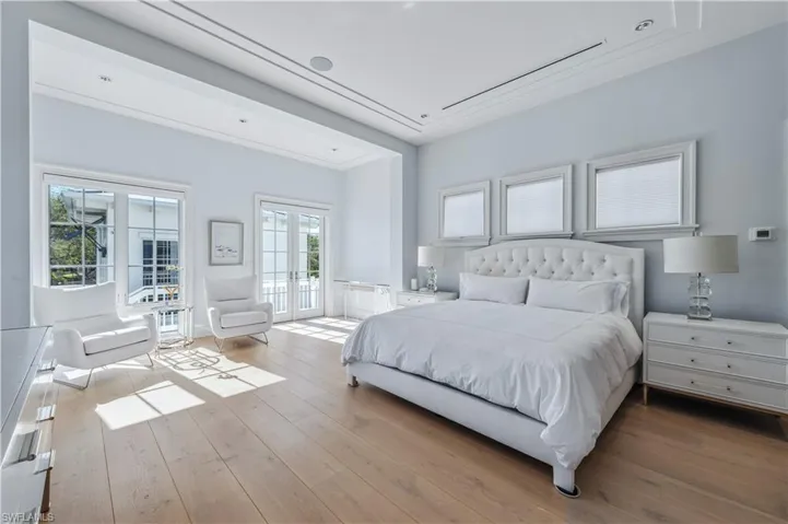 Bedroom with access to exterior, french doors, and light hardwood / wood-style floors