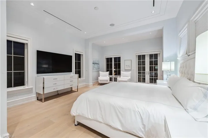 Bedroom with french doors and light wood-type flooring