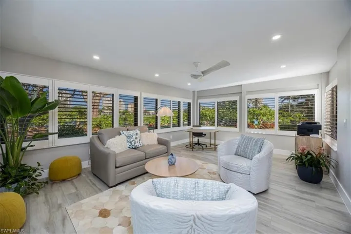 Den/office with ceiling fan and light hardwood / wood-style flooring