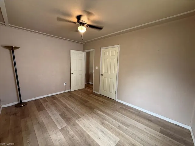 Unfurnished bedroom featuring ceiling fan and light wood-type flooring