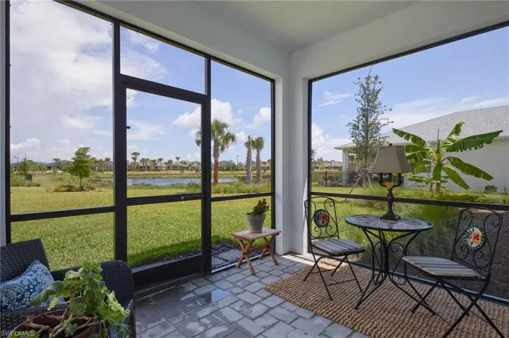 Sunroom / solarium featuring a water view