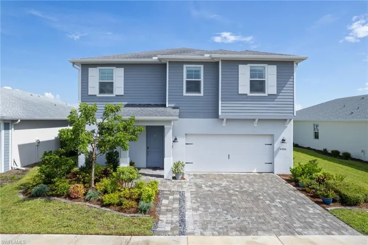 View of 2 story front of house with a garage