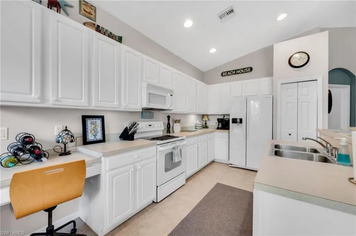 Crisp white cabinetry, stainless steel appliances, and ample counter space for any chef.