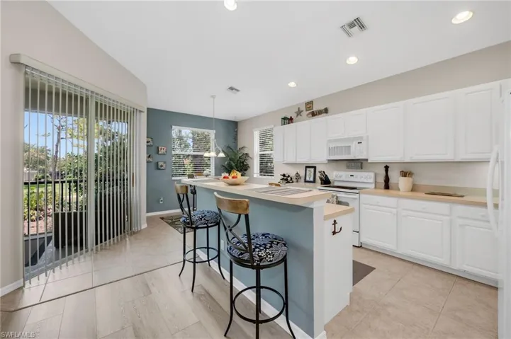 Kitchen offers open sightlines to lanai and living area, enhancing livability.