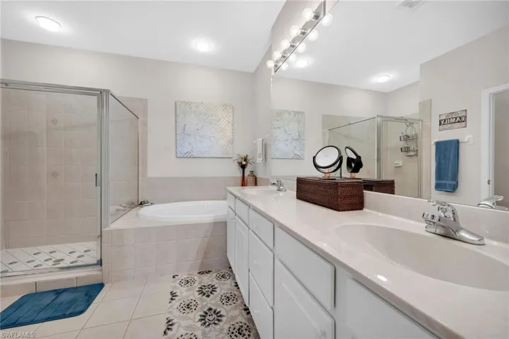 Dual vanities, walk-in shower, and soaking tub create a luxurious escape.