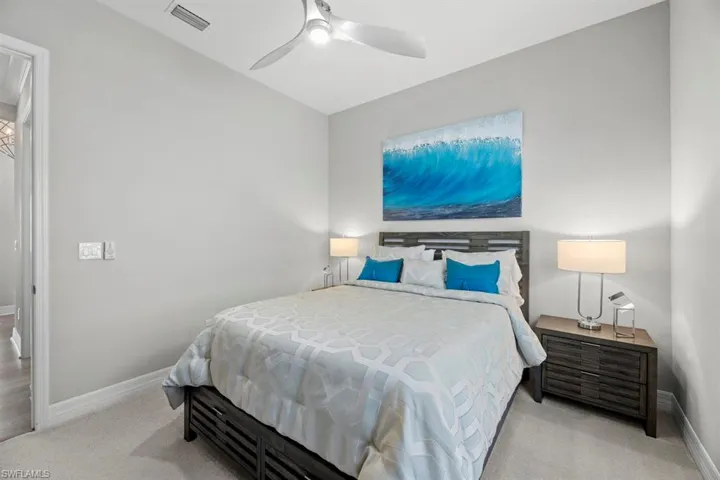 Carpeted bedroom with ceiling fan