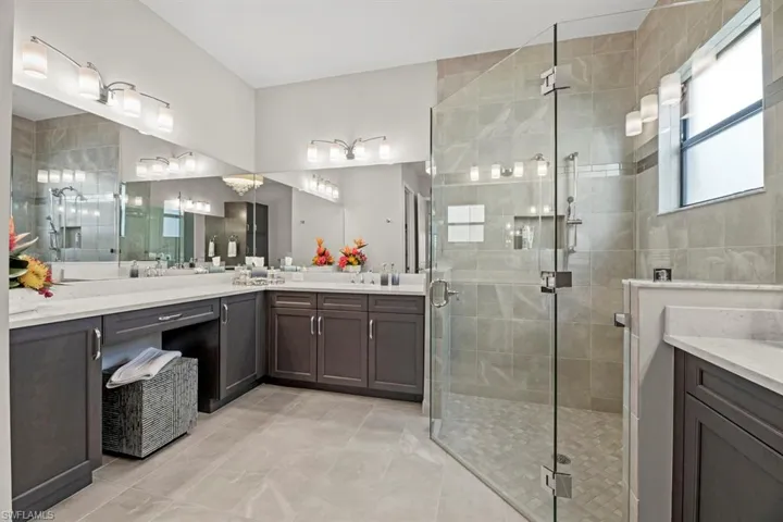 Bathroom featuring vanity and a shower with shower door