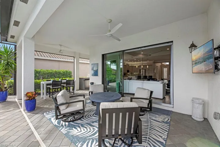 View of patio featuring an outdoor hangout area and ceiling fan