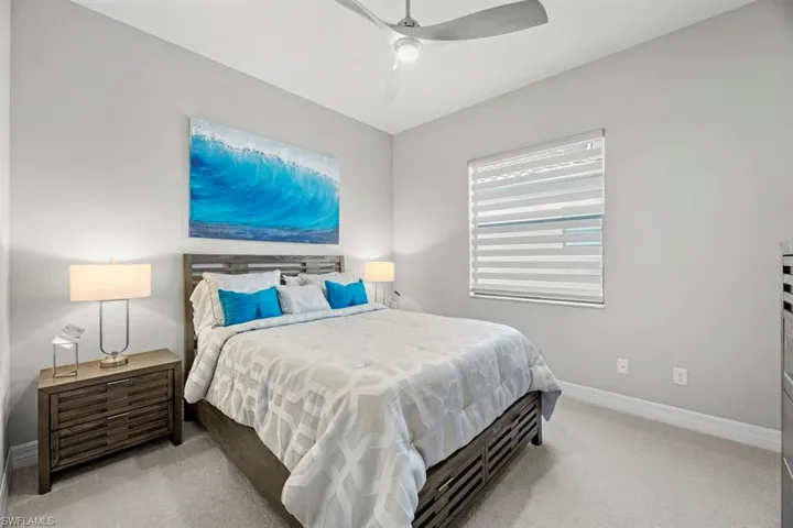 Bedroom featuring ceiling fan and light carpet