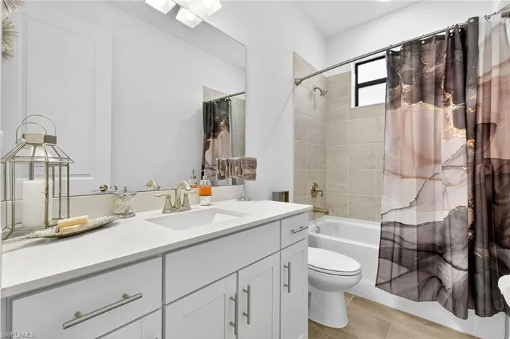 Bathroom with vanity and shower / bath combo with shower curtain