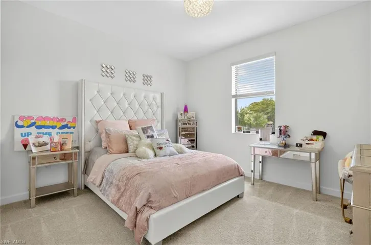 Carpeted bedroom featuring baseboards