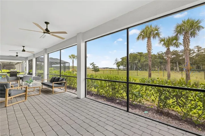Sunroom featuring a ceiling fan and outdoor lounge area