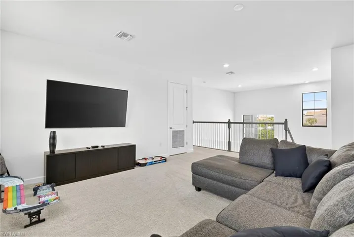 Living area featuring recessed lighting and carpet floors