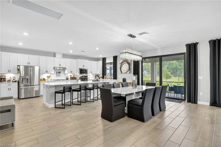 Dining area featuring recessed lighting and light wood-style flooring