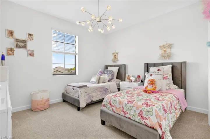 Bedroom with a chandelier and carpet floors