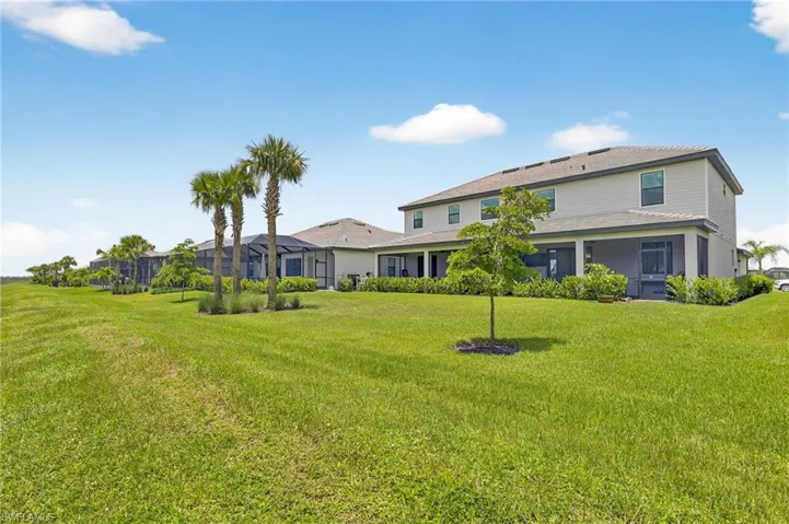 Back of property with a lawn