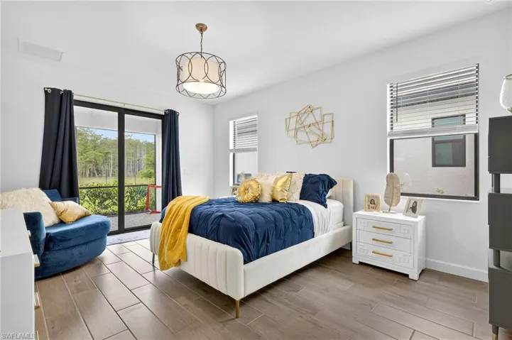 Bedroom featuring access to exterior and wood finished floors