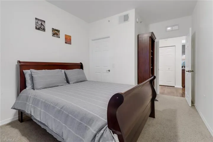 Carpeted bedroom with a closet