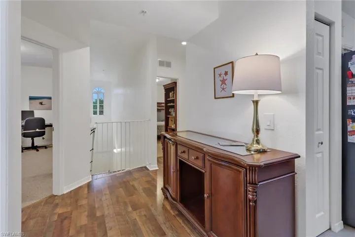 Corridor featuring dark hardwood / wood-style flooring