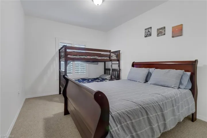 Bedroom featuring light colored carpet