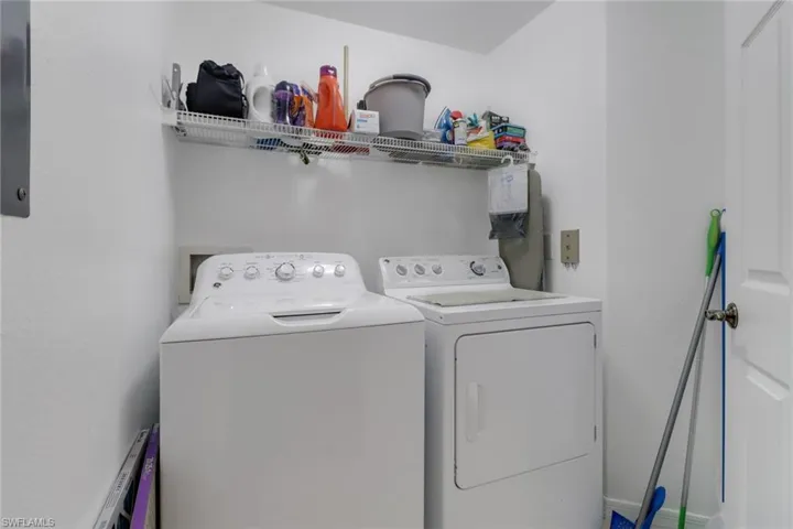 Clothes washing area featuring washer and dryer