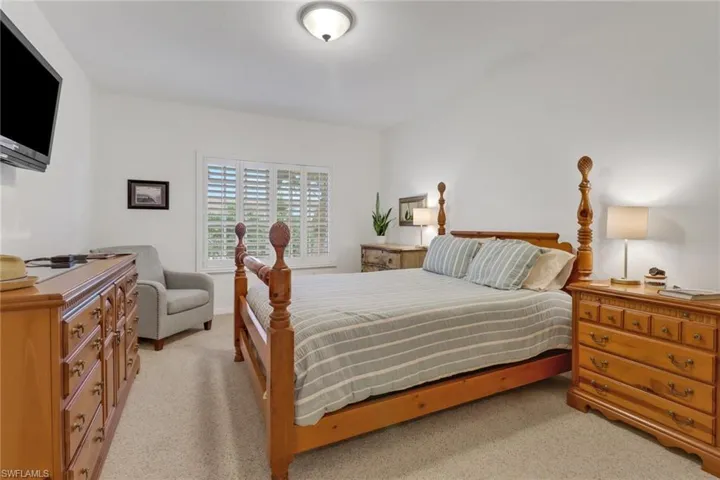 Bedroom with light colored carpet