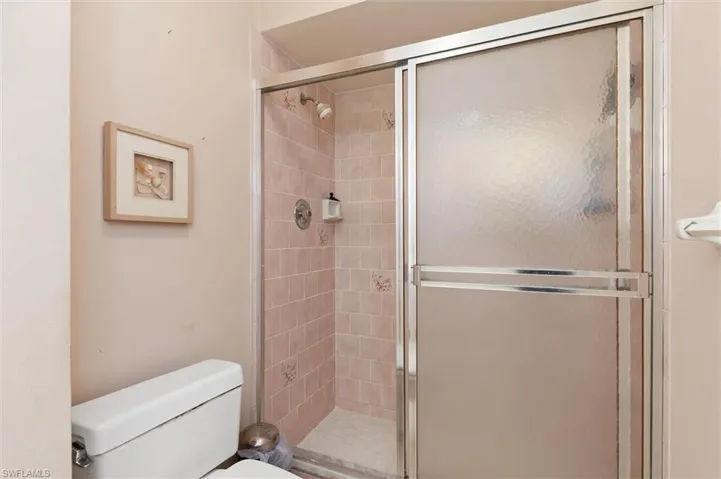 Bathroom with a stall shower and toilet