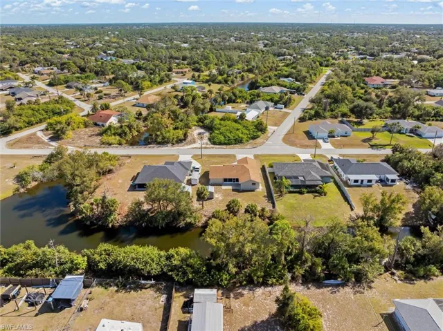 Aerial view of property's location featuring nearby suburban area and a large body of water