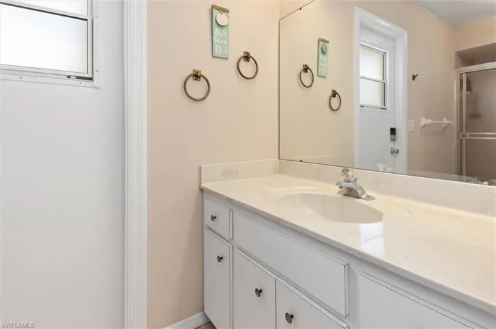 Full bathroom with vanity and an enclosed shower