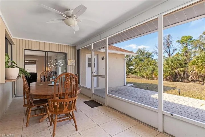 Sunroom / solarium featuring ceiling fan and outdoor dining space
