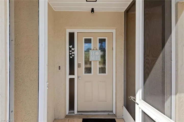 Entrance to property featuring stucco siding